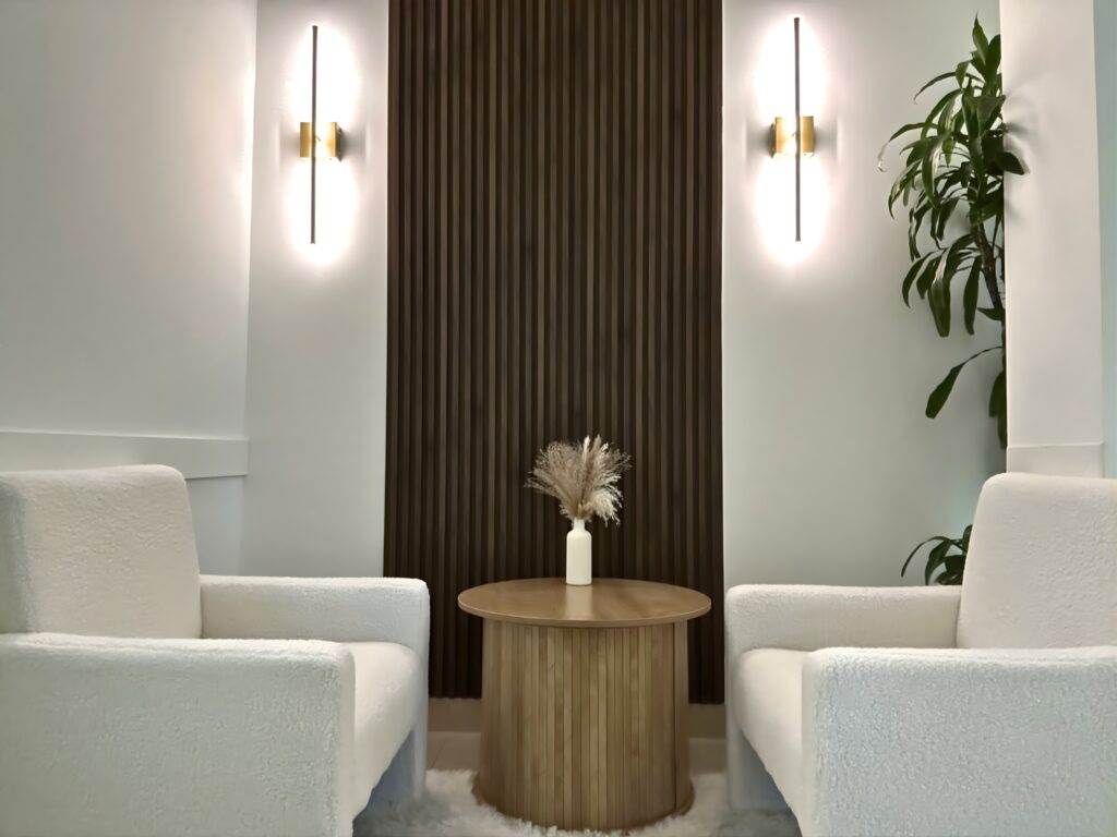 Elegant waiting area at Momentum Medspa featuring white chairs and warm lighting